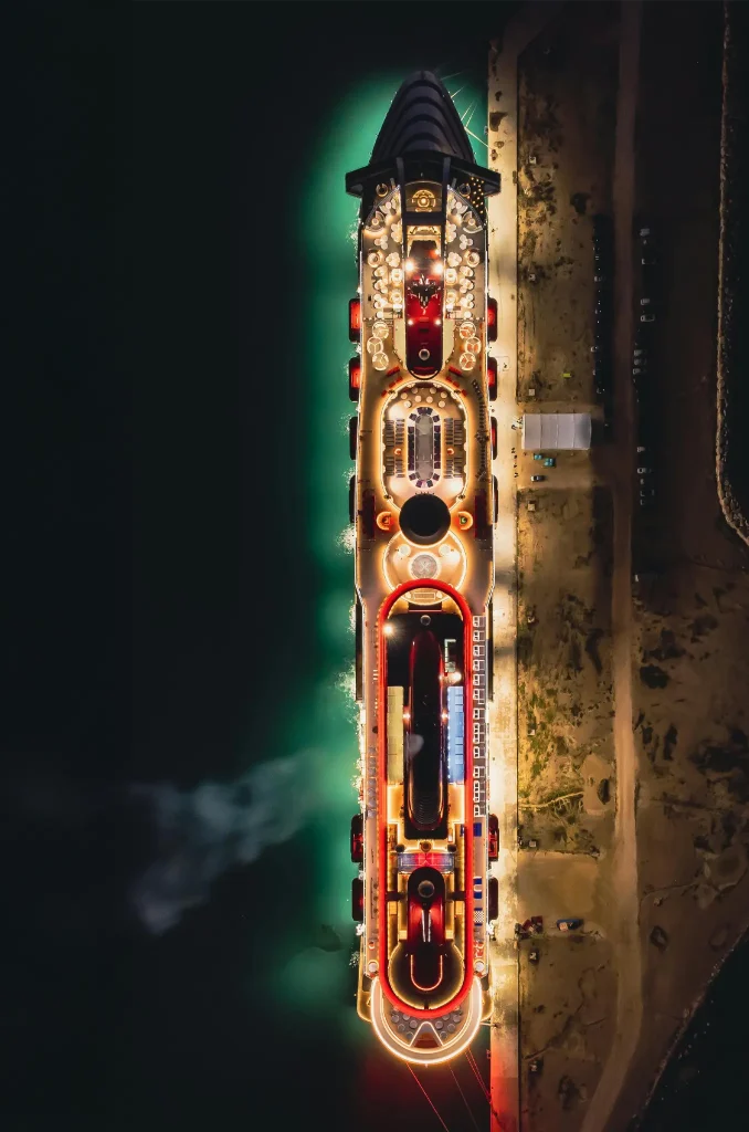 Top View of an Illuminated Cruise Ship in a Dock at Night. Photo by Angelo Esposito.