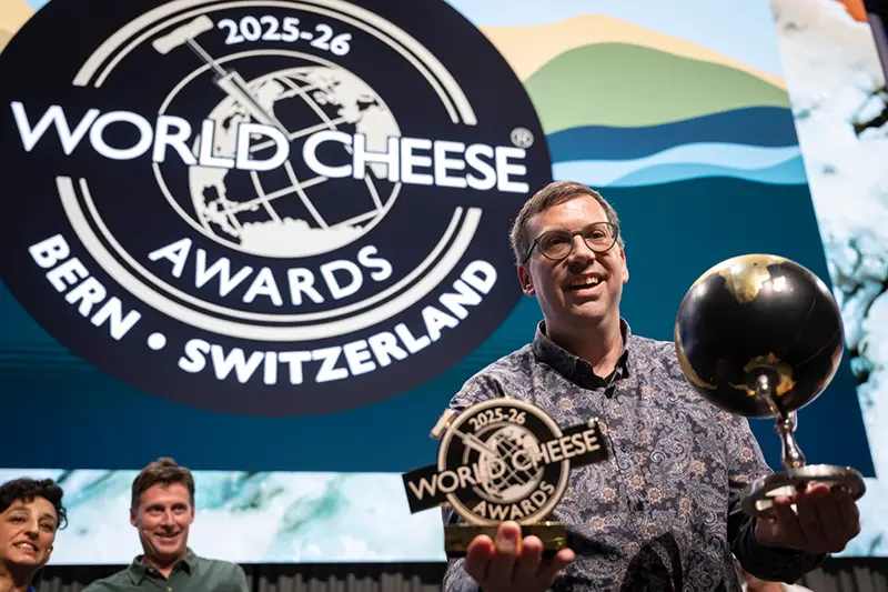 Swiss cheesemaker Pius Hitz from the Vorderfultigen cheese company lifts the trophy after winning the World Cheese Awards, after the final of the 37th World Cheese Awards, at the Festhalle in Bern, Switzerland, Thursday, Nov. 13, 2025. (Anthony Anex/Keystone via AP)