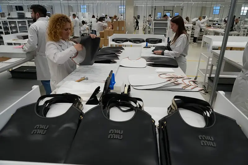 Leather good operators work at the Prada factory in Scandicci, Italy, Friday, Nov. 28, 2025. (AP Photo/Gregorio Borgia)