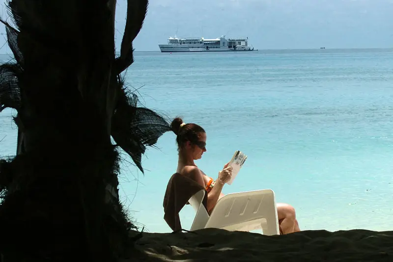 A tourist relaxes on a beach on the Kurumathi Island, west of The Maldives' capital Male. (Photo by LAKRUWAN WANNIARACHCHI/AFP via Getty Images)