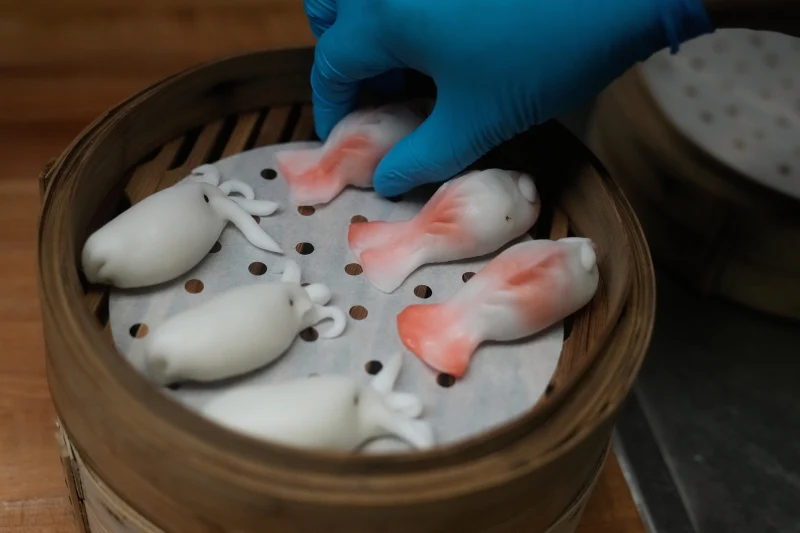 A kitchen worker prepares dumplings at the Empress by Boon restaurant in San Francisco, Thursday, Jan. 8, 2026. (AP Photo/Jeff Chiu)