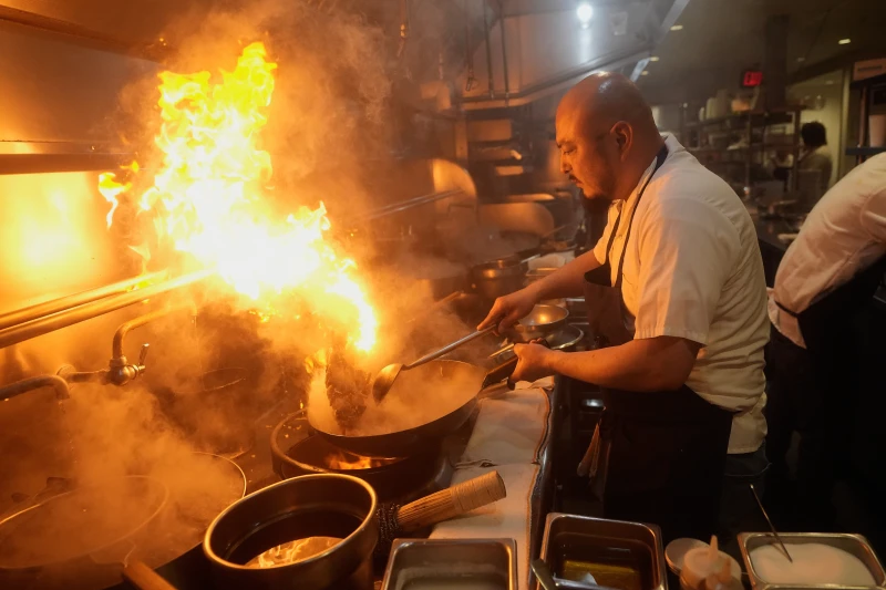 Sous chef Frank Bonilla cooks House Famous Kung Pao Firecracker chicken at China Live in San Francisco, Thursday, Jan. 8, 2026. (AP Photo/Jeff Chiu)