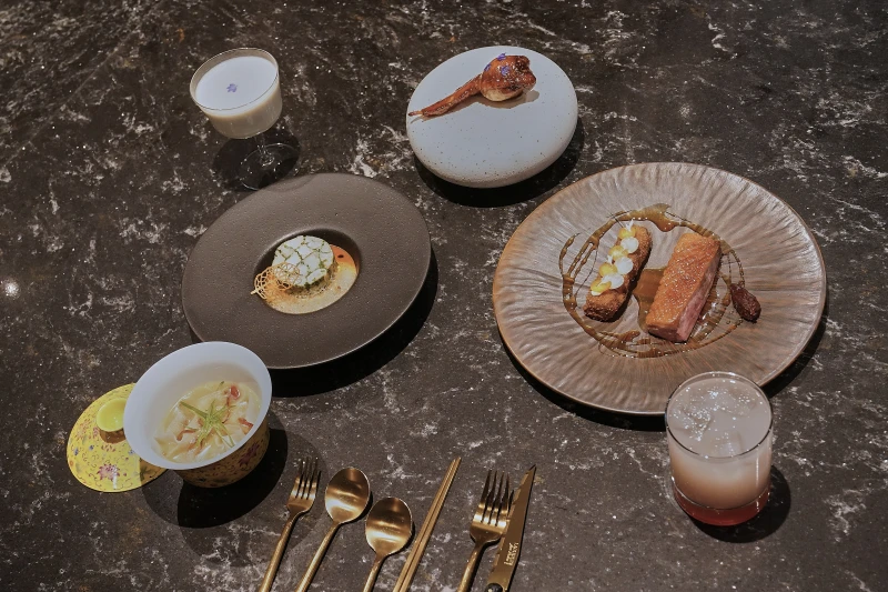 Dishes prepared at Michelin-starred Chinese restaurant Yingtao, from lower left, Chicken Broth Wonton, Black Cod, Lo Mai Gai and Plum Duck are displayed in New York, Tuesday, Jan. 27, 2026. (AP Photo/Richard Drew)