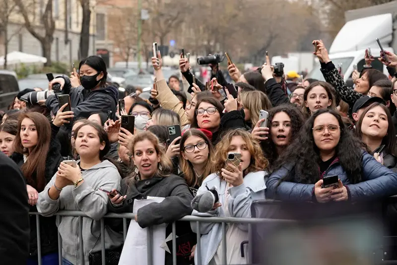Fans wait for celebrities outside the Fendi Fall/Winter 2026-2027 Women’s collection presented in Milan, Italy, Wednesday, Feb. 25, 2026. (AP Photo/Luca Bruno)