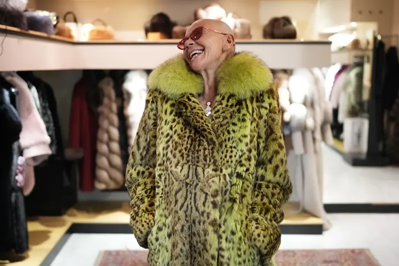 Paola De Leidi poses for a photo wearing a fur coat after an interview with The Associated Press in the Pajaro shop, in Cortina d’Ampezzo, Italy, Saturday, Feb. 14, 2026. (AP Photo/Alessandra Tarantino)