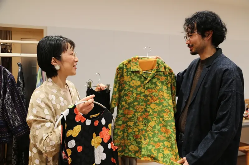 Designer Tomoko Ohkata, left, and her assistant Koki Unami hold Ohkata’s designs made from old kimono, in Tokyo, on Jan. 15, 2026. (AP Photo/Yuri Kageyama)