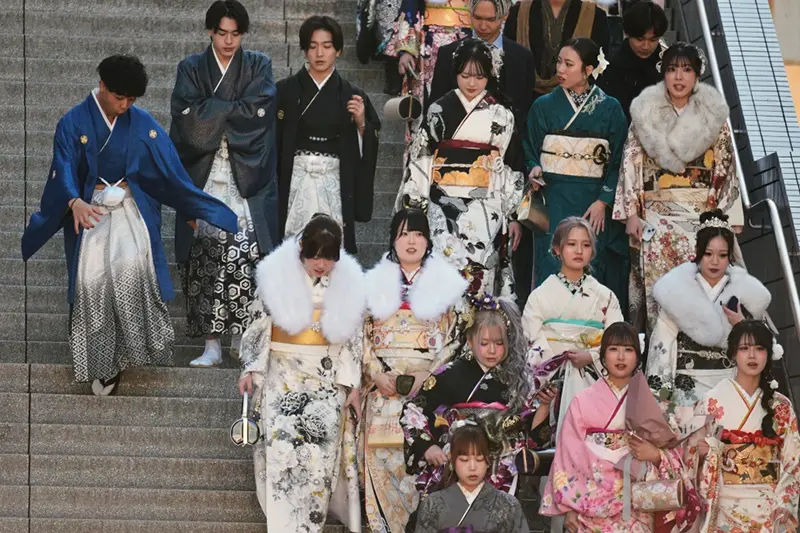 Young adults arrive at a venue to celebrate the Coming-of-Age Day, a centuries-old tradition and national holiday marking the milestone from childhood to adulthood, Jan. 12, 2026, in Yokohama near Tokyo. (AP Photo/Eugene Hoshiko, File)