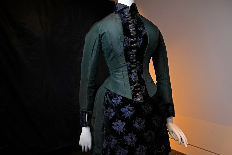 A vintage walking dress is held in preparation for The Metropolitan Museum of Art’s spring exhibition, “Costume Art,” on Thursday, Feb. 12, 2026, in New York. (Photo by Charles Sykes/Invision/AP)