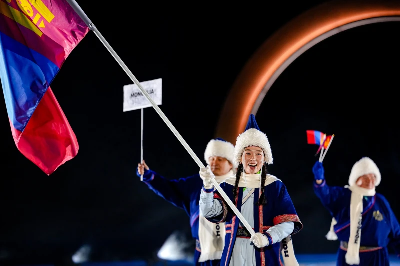 Ariuntungalag Enkhbayar, the flag bearer of Mongolia, takes part in the athletes parade during the Olympic opening ceremony at the 2026 Winter Olympics, in Predazzo, Italy, Friday, Feb. 6, 2026. (AP Photo/Matthias Schrader)