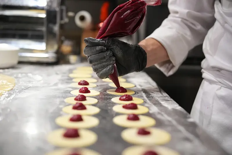 Local chef Gianluca Belli demonstrates how to make Casunziei, a type of ravioli that is Cortina’s signature dish, during a pasta-making tutorial at a Michelin one-star restaurant in Cortina D’Ampezzo, Friday, Nov. 21, 2025. (AP Photo/Andrew Medichini)