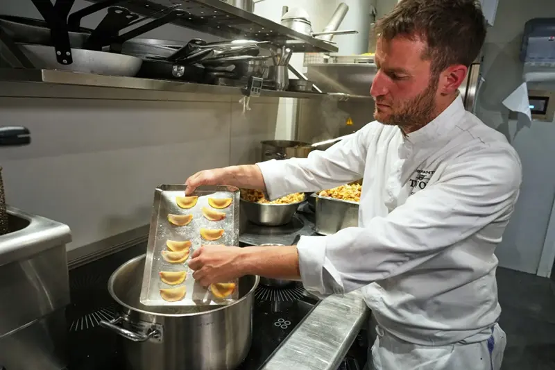 Local chef Gianluca Belli demonstrates how to make Casunziei, a type of ravioli that is Cortina’s signature dish, during a pasta-making tutorial at a Michelin one-star restaurant in Cortina D’Ampezzo, Friday, Nov. 21, 2025. (AP Photo/Andrew Medichini)