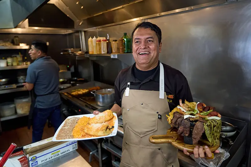 Mexican restaurant owner-chef Marco Mendoza prepares a hot molcajete, a traditional Mexican dish, at Cuernavaca’s Grill in downtown Los Angeles, Tuesday, April 28, 2026. (AP Photo/Damian Dovarganes)