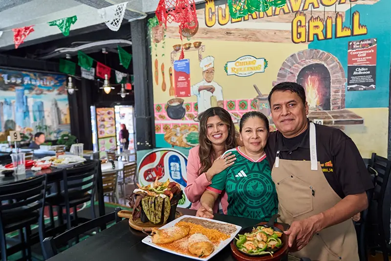Chef Marco Mendoza, right, his wife Maria Luisa Mendoza, center, and daughter Nayomie Mendoza, pose for a picture at their Mexican restaurant Cuernavaca’s Grill in downtown Los Angeles, Tuesday, April 28, 2026. (AP Photo/Damian Dovarganes)