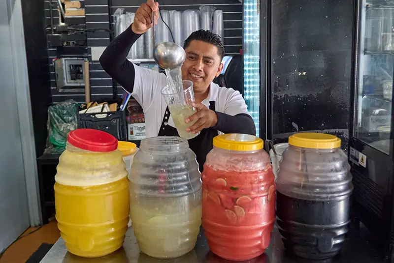 Waiter Usiel Macias serves a lemonade at Cuernavaca’s Grill downtown Los Angeles, Tuesday, April 28, 2026. (AP Photo/Damian Dovarganes)