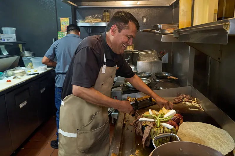 Mexican restaurant owner-chef Marco Mendoza prepares a hot molcajete, a traditional Mexican dish, at Cuernavaca’s Grill in downtown Los Angeles, Tuesday, April 28, 2026. (AP Photo/Damian Dovarganes)