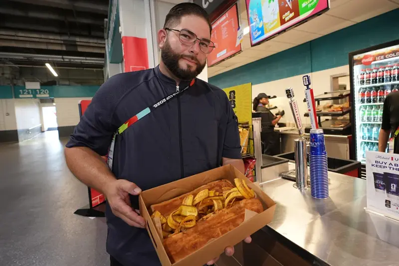 Lazaro Luya, the concession chef at Sol Cubano, displays their special, pan with lechon and fresh mariquitas at Miami Stadium Sunday, June 21, 2026, in Miami Gardens, Fla. (AP Photo/Marta Lavandier)