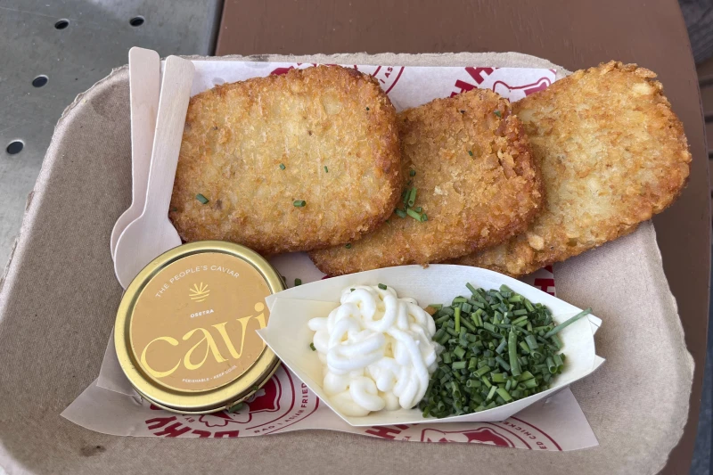 A $75 dish called “Fancy AF Tots” is shown containing fried hash brown potatoes, caviar, crème fraiche and chives at a World Cup match at Miami Stadium in Miami Gardens, Fla., Sunday, June 21, 2026. (AP Photo/Tim Reynolds)