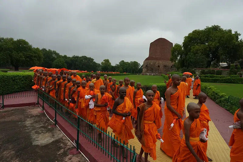 Novice monks walk in a procession near Dhamek Stupa in Sarnath, India, Sunday, July 19, 2026. (AP Photo/Rajesh Kumar Singh)