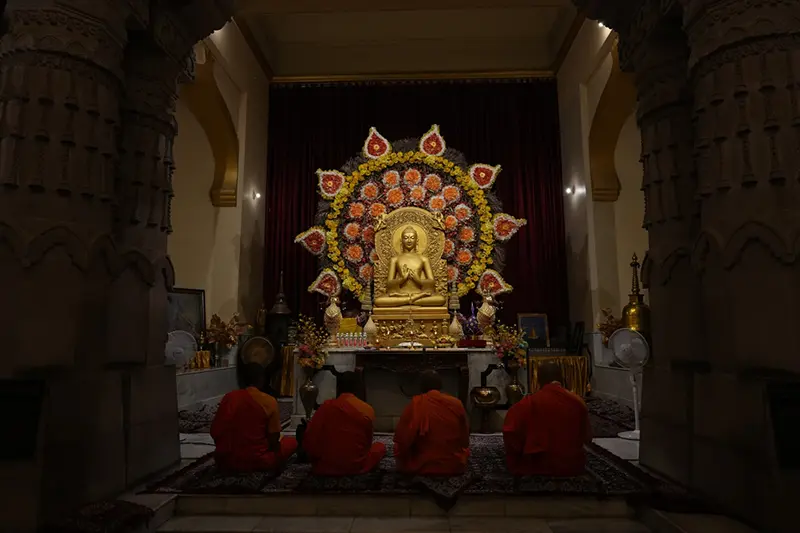 Buddhist monks pray inside a monastery in Sarnath, India, Saturday, July 18, 2026. (AP Photo/Rajesh Kumar Singh)