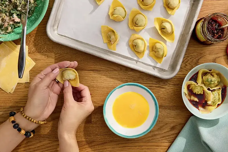 This image released by S&S/Element shows a recipe for Popo’s wontons from the cookbook, “Have You Eaten Yet?,” by Ming-Na Wen. (Jennifer Chong/S&S/Element via AP)